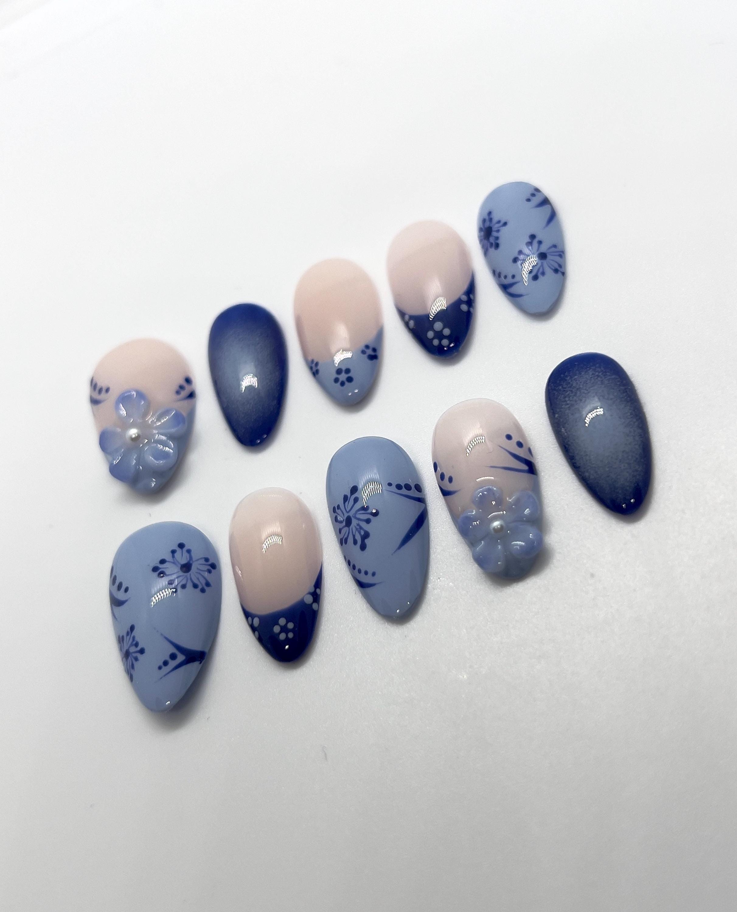 Handmade blue and beige press-on nails with Blue Floral Bloom design on a white background