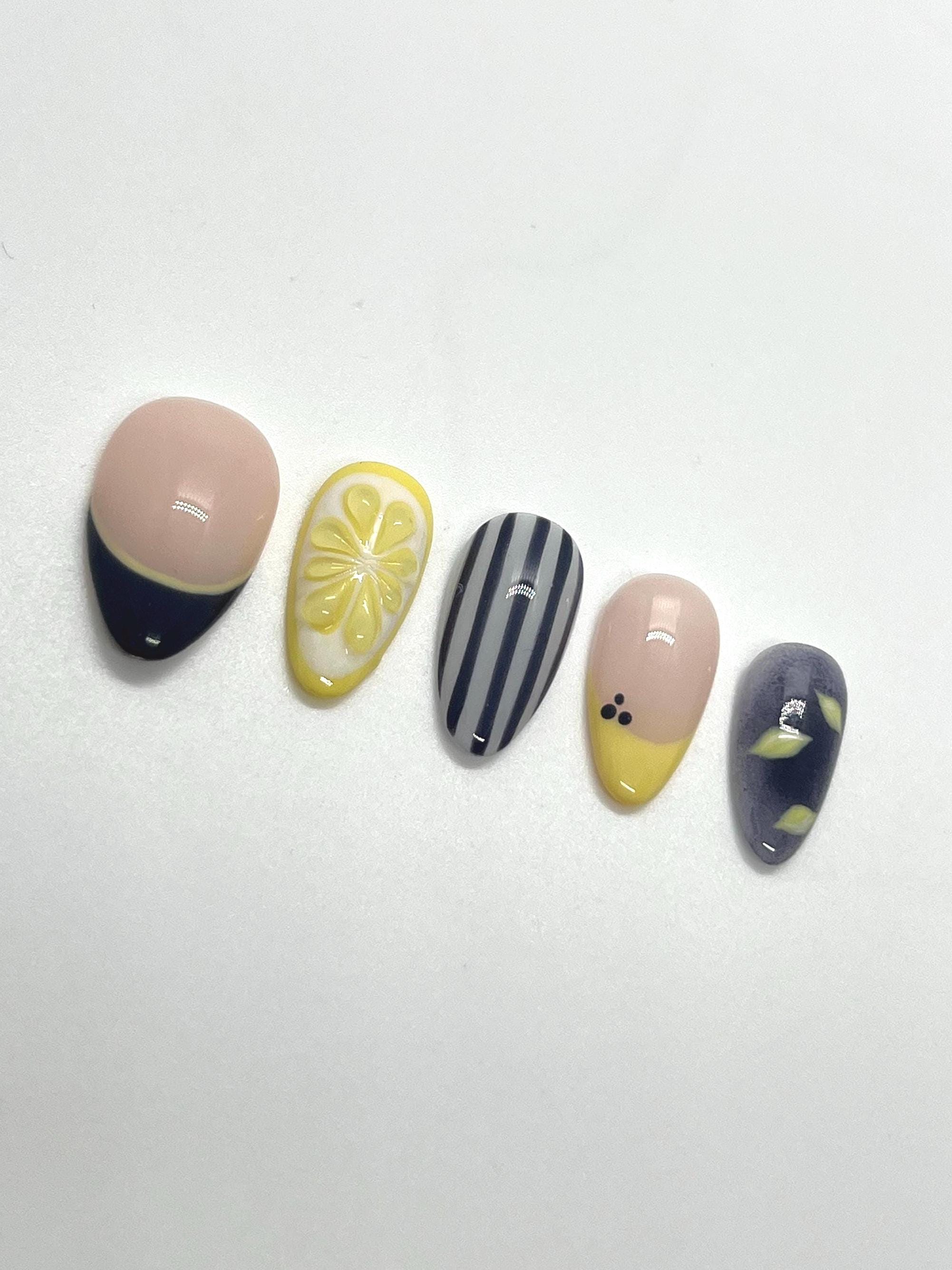Handmade press-on nails with Blueberry Lemonade design on a white background