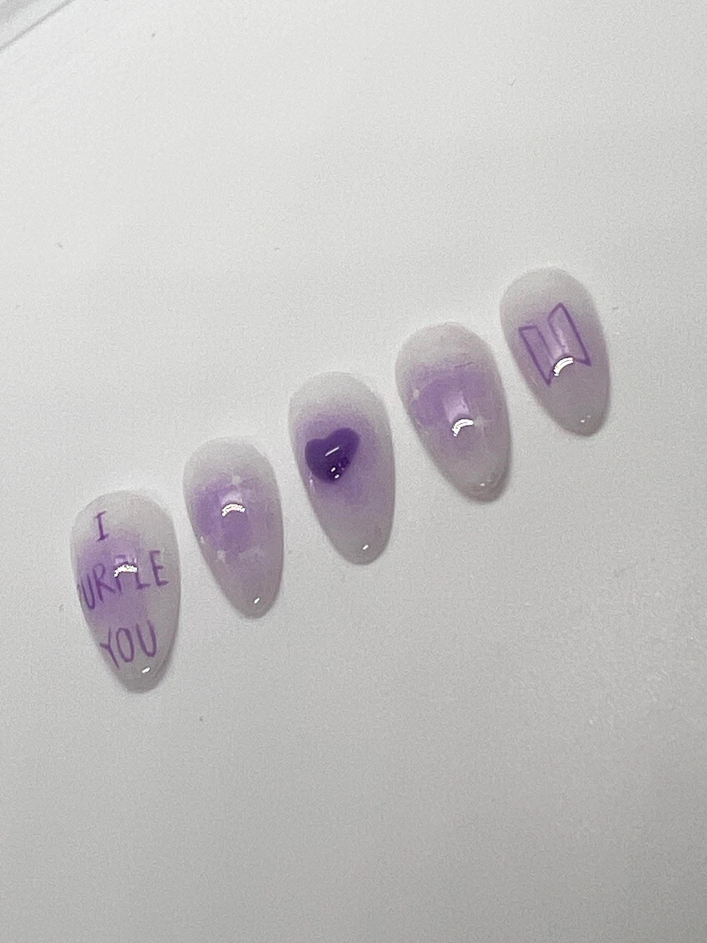 This BTS-inspired handmade press-on nail set features purple and white gradient tones with elegant detailing, inspired by BTS’s signature purple. Designed to represent love, trust, and the lasting bond between artist and fans, these nails are perfect for ARMYs who want a subtle yet meaningful look.