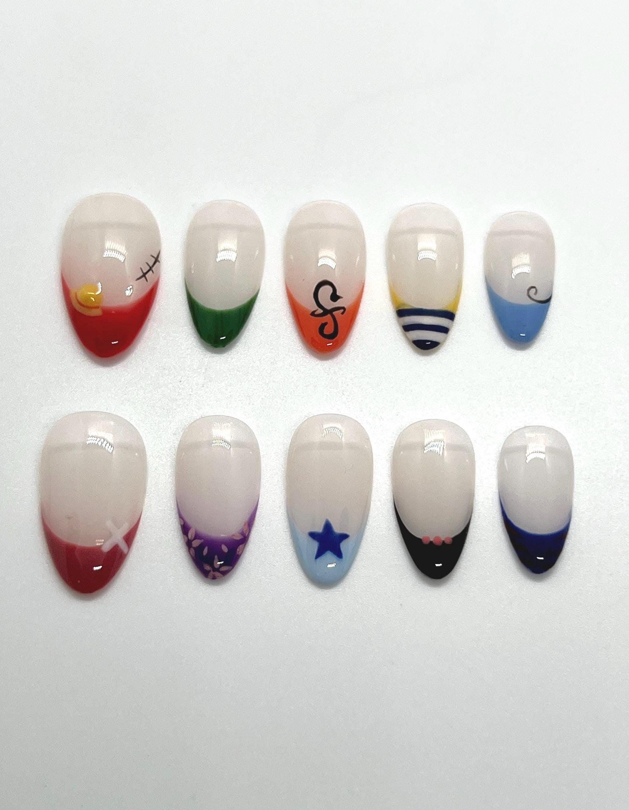 Handmade press-on nails with Straw Hat Crew design on a white background