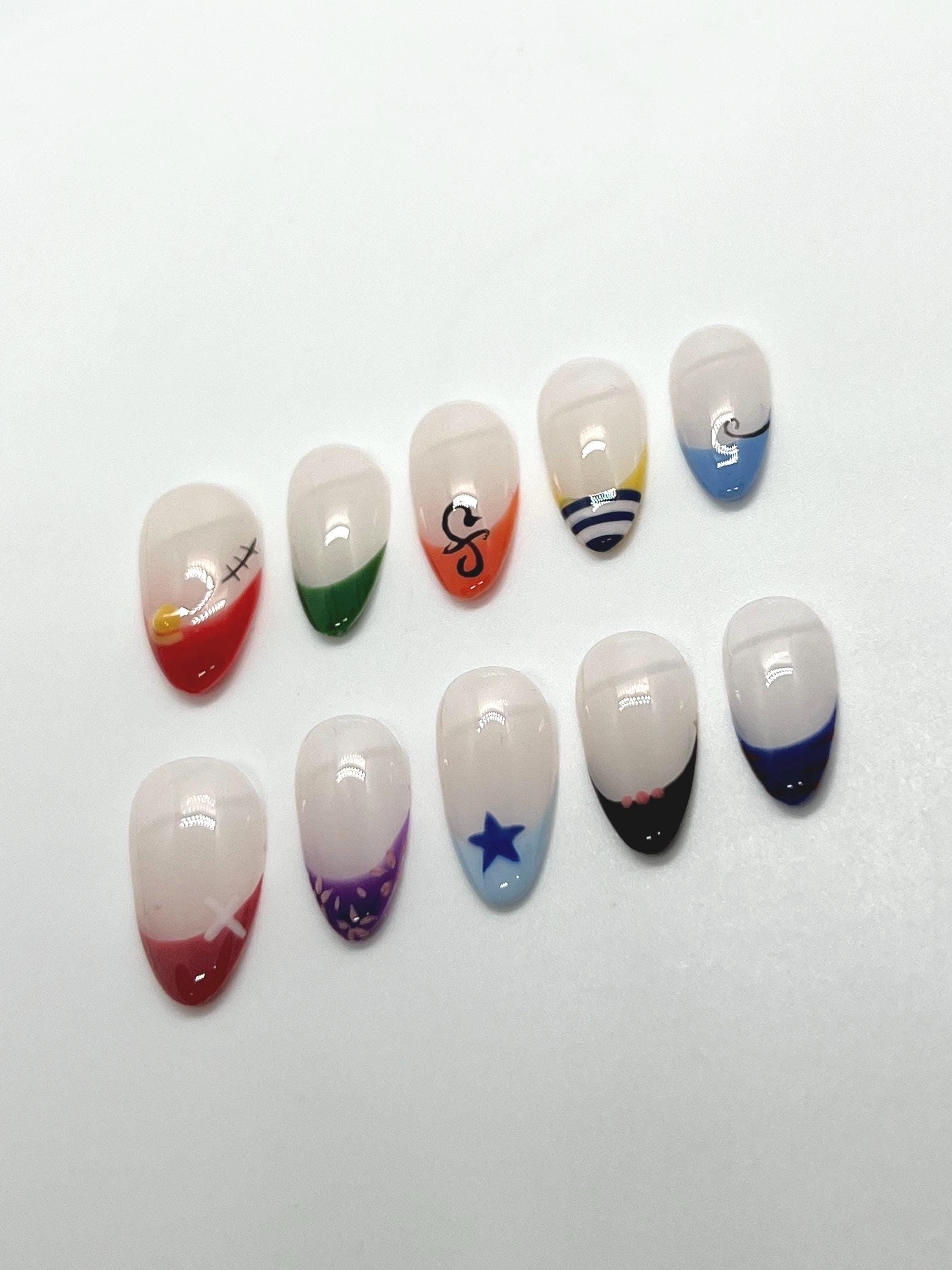 Handmade press-on nails with Straw Hat Crew design on a white background