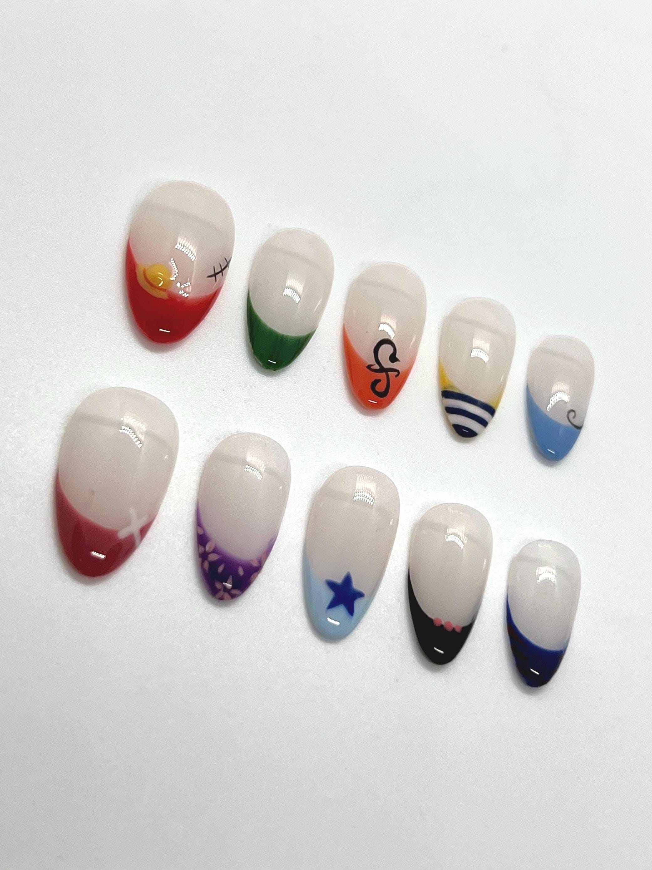 Handmade press-on nails with Straw Hat Crew design on a white background